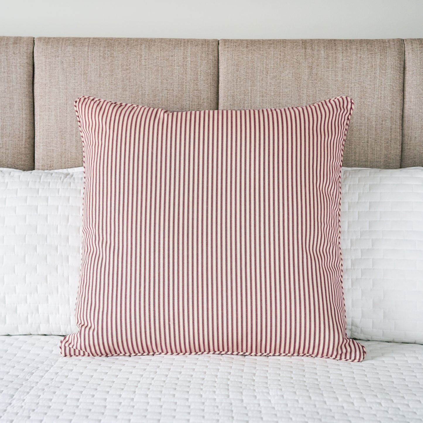 red and ivory striped pillow sham european size on bed