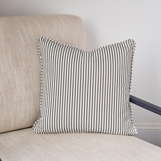 ticking stripe throw pillow black and cream  on chair