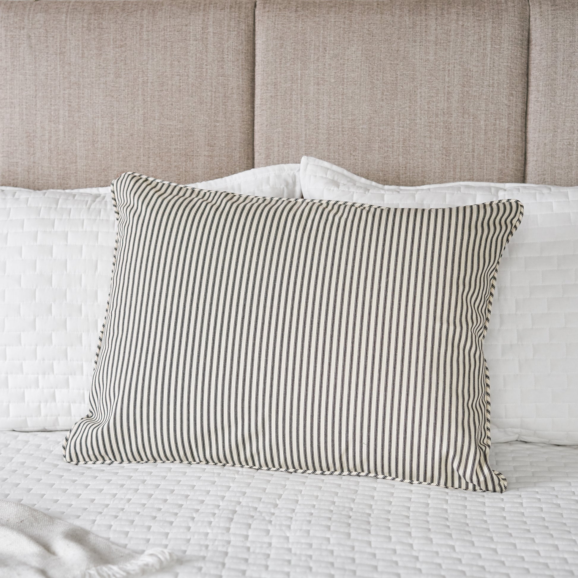 black and white ticking stripe fabric pillow sham on bed