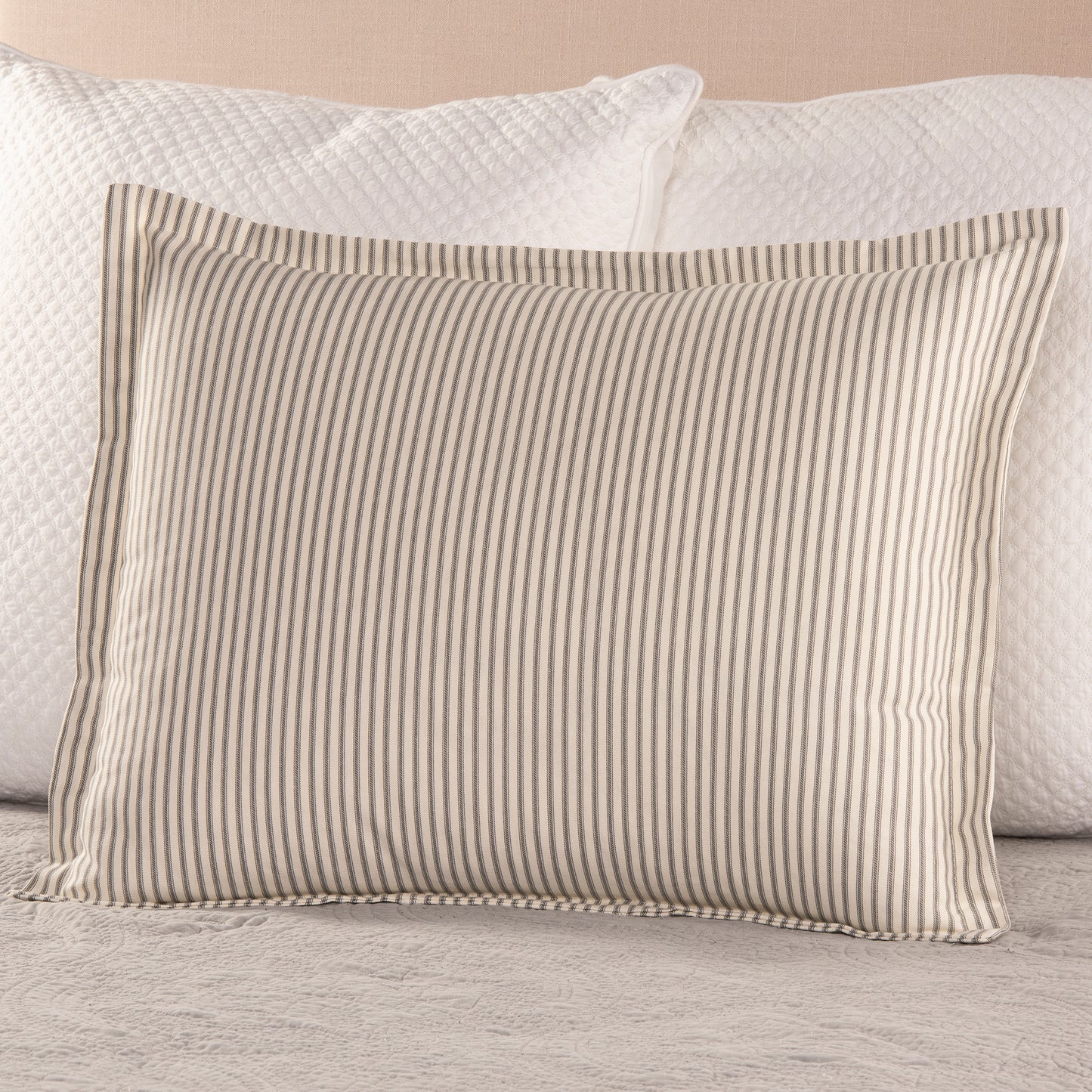 Gray ticking stripe standard sham with flange on bed