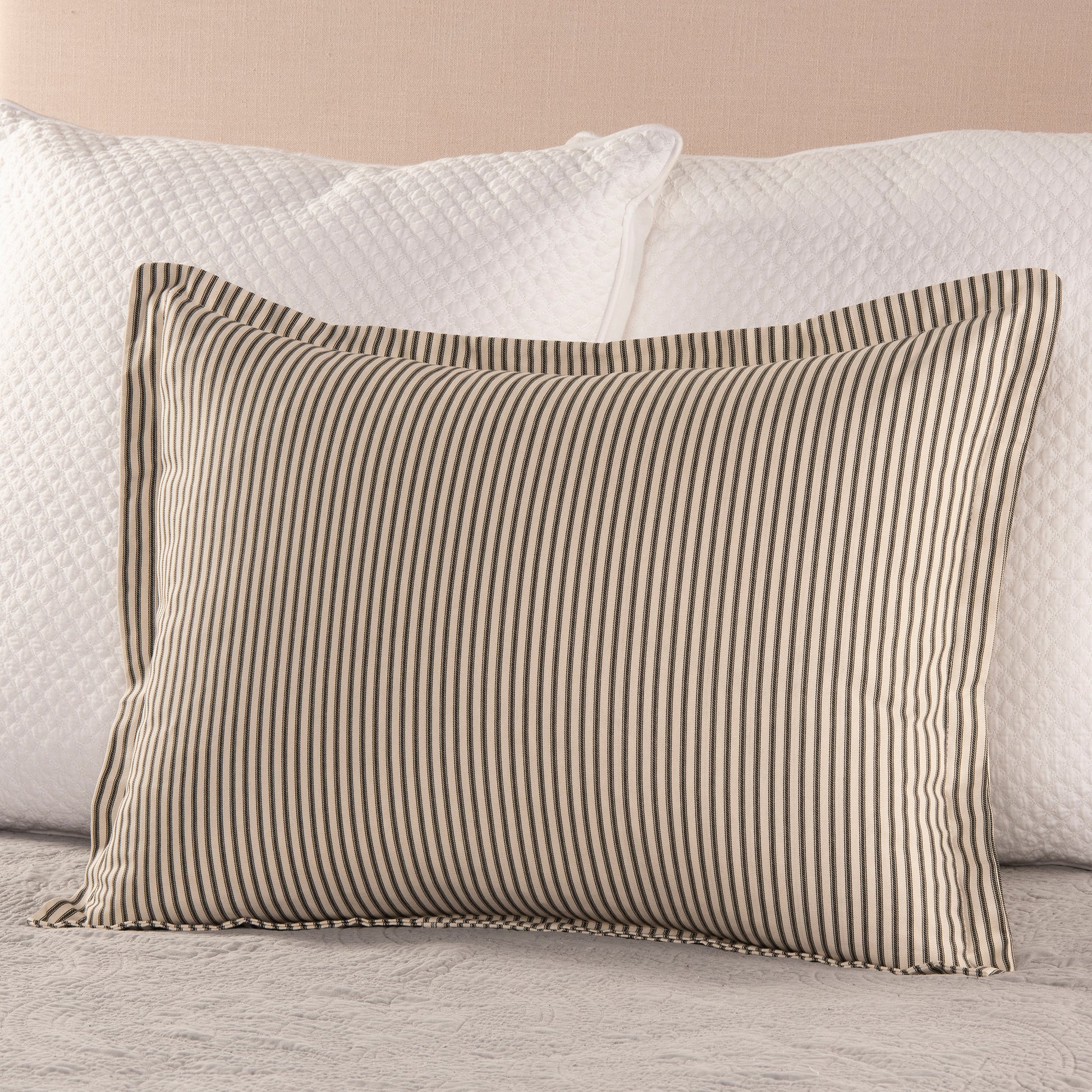 black and cream ticking stripe flange pillow sham on bed