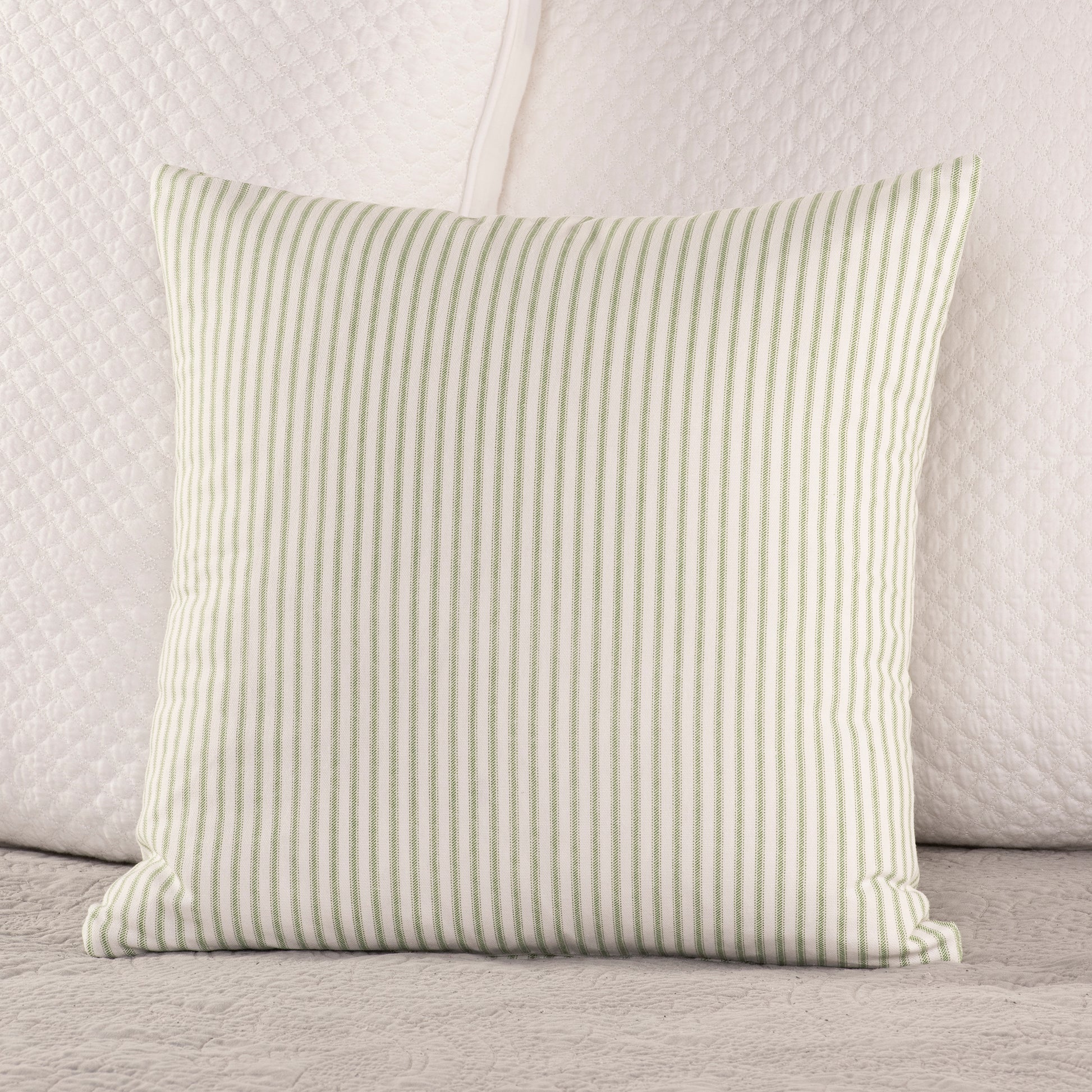 pine green and white ticking stripe throw pillow on bed