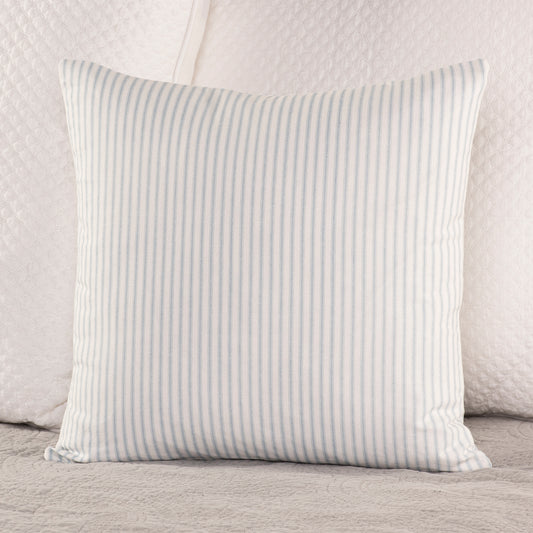 soft weathered blue and white ticking stripe throw pillow on bed